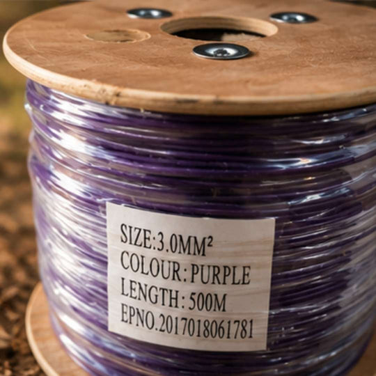 Spool of purple wire with a label on a wooden reel