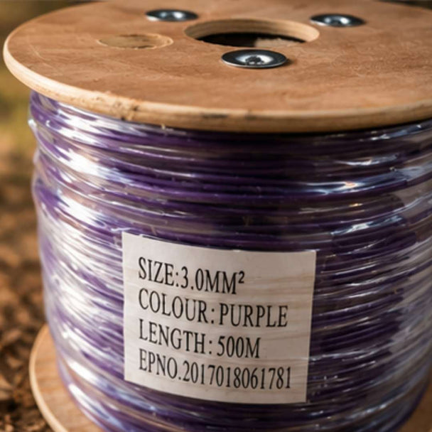 Spool of purple wire with a label on a wooden reel